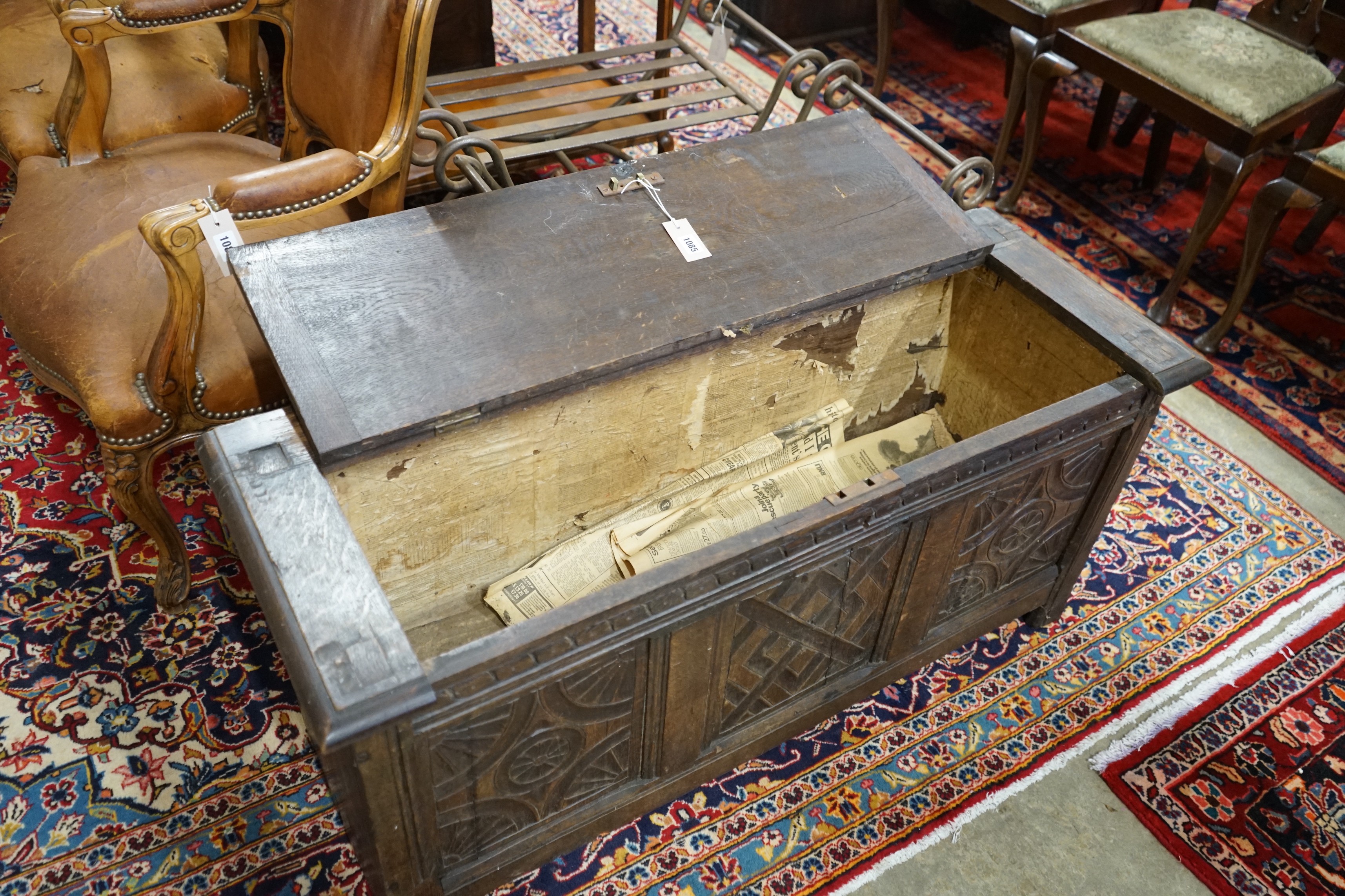 An 18th century style carved oak coffer converted from a monk's bench, width 112cm, depth 41cm, height 52cm